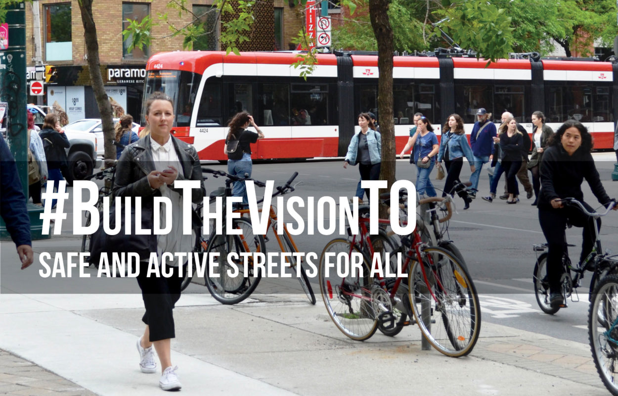 Photo of a street in Toronto with pedestrians, cyclists and a streetcar. Words on the image say: Build The Vision TO, Safe and Active Streets for All