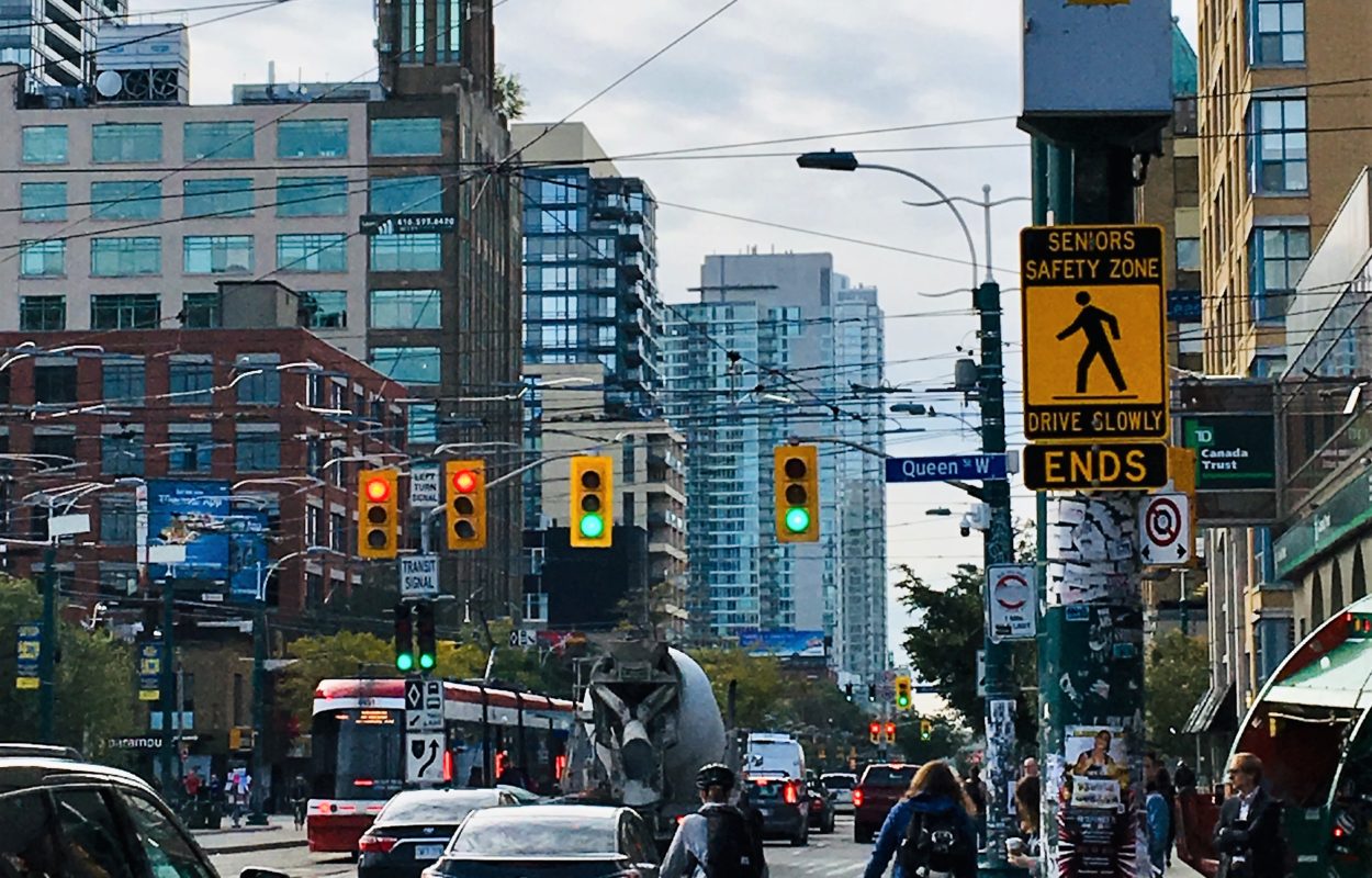 A Toronto street with a "Senior's Safety Zone Ends" sign