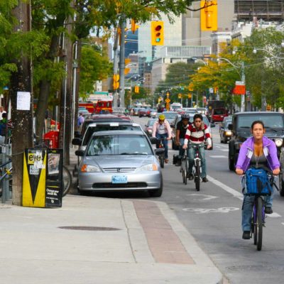 Cyclists, cars and public transit on College Street in Toronto